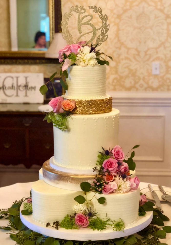 White and Gold Buttercream Wedding Cake with Fresh Flowers and Multi-Cake Base